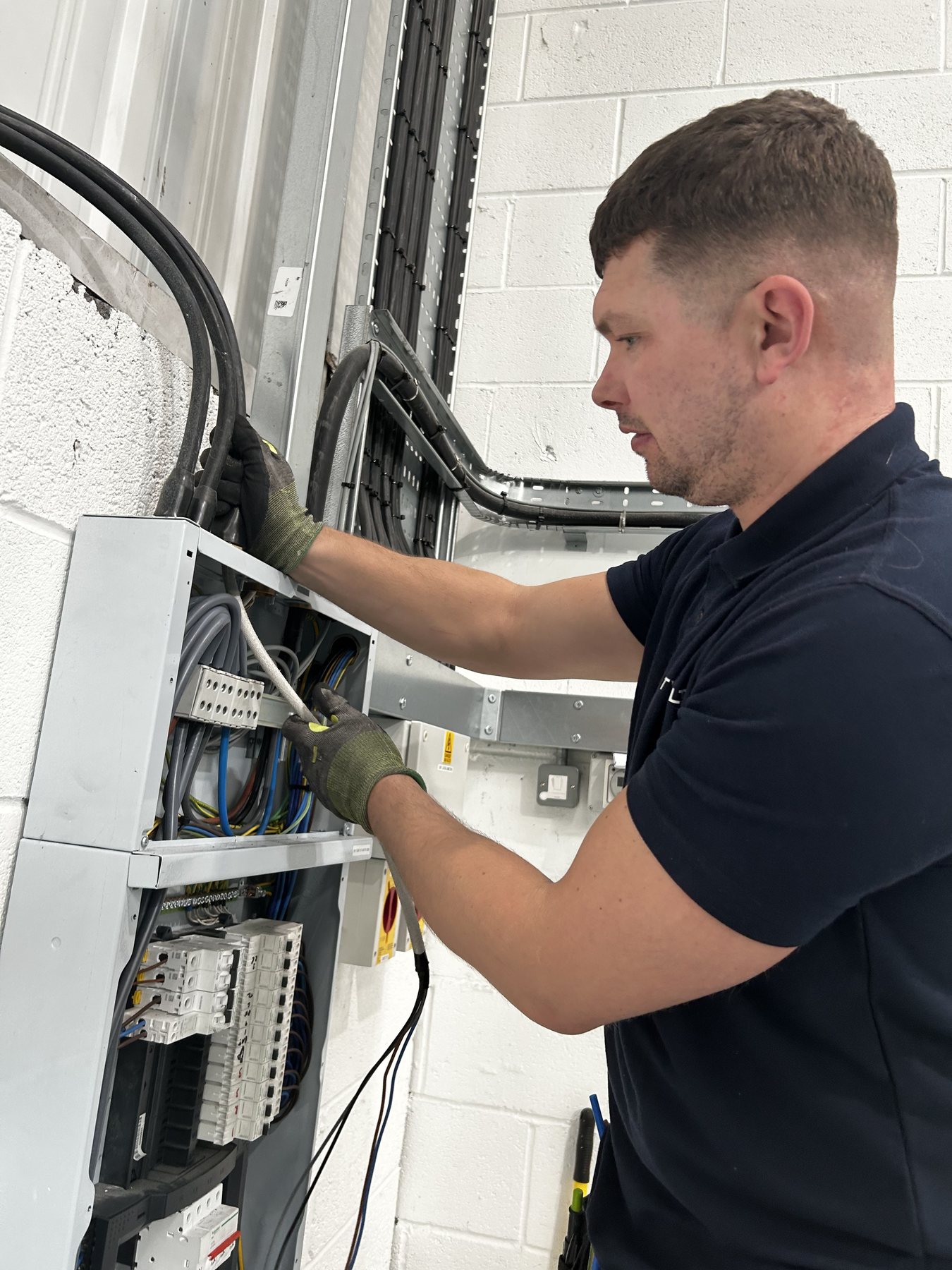 Glenn working at the electrical panel at Pikup Padel